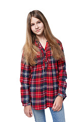 Image showing Teen girl in checkered shirt standing casually