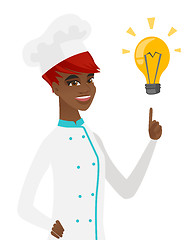 Image showing Young african-american chef pointing at lightbulb.