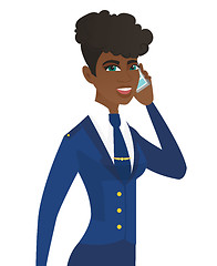 Image showing Young african stewardess talking on a mobile phone