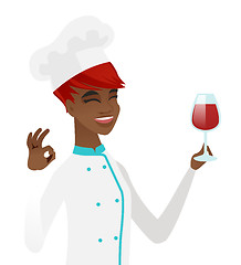 Image showing Chef holding glass of wine and showing ok sign.