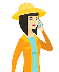 Image showing Young asian farmer talking on a mobile phone.