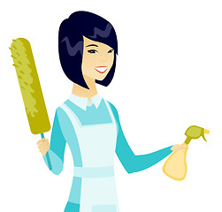 Image showing Asian housemaid holding spray bottle and duster.