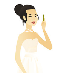 Image showing Young asian smiling fiancee with pen.