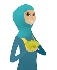 Image showing Young muslim business woman holding money.