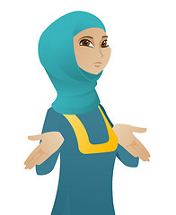 Image showing Confused muslim business woman shrugging shoulders