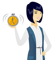 Image showing Young asian business woman holding alarm clock.