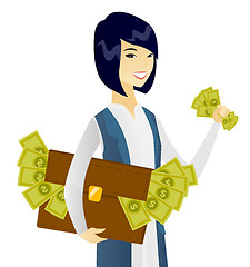 Image showing Asian business woman with briefcase full of money.