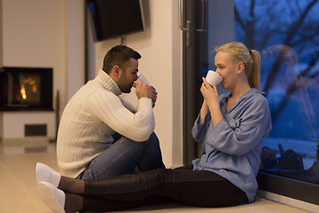 Image showing happy couple in front of fireplace