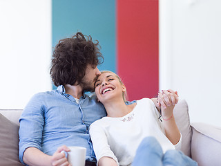 Image showing Young couple on the sofa watching television