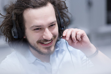 Image showing male call centre operator doing his job