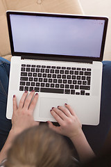 Image showing young woman on sofa at home websurfing