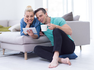 Image showing couple relaxing at  home with tablet computers