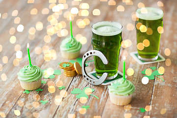 Image showing glass of beer, cupcakes, horseshoe and gold coins