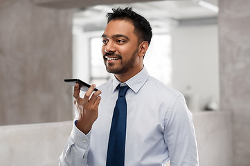 Image showing businessman using voice command on smartphone