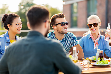 Image showing friends having dinner or bbq party on rooftop