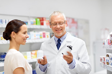 Image showing apothecary and woman with drug at pharmacy