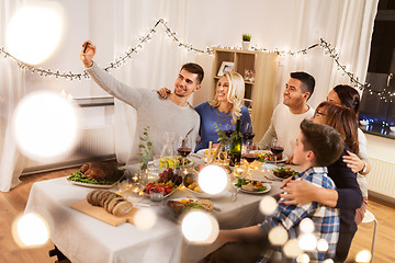 Image showing family having dinner party and taking selfie