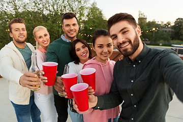 Image showing friends with drinks taking selfie at rooftop party