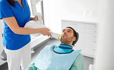 Image showing dentist making dental x-ray of patient teeth