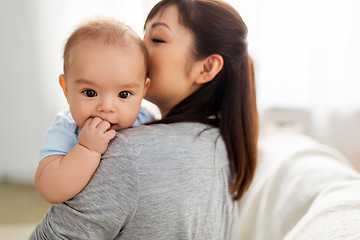 Image showing close up of happy mother kissing baby son at home