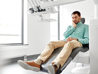 Image showing patient suffering from toothache at dental clinic