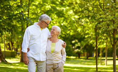 Image showing happy senior couple hugging in city park