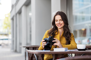 Image showing tourist or teenage girl with camera at city cafe