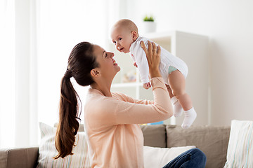 Image showing happy mother playing with little baby boy at home