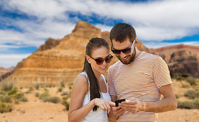Image showing happy couple with smartphone in summer