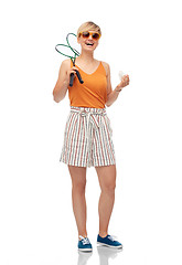 Image showing teenager with badminton rackets and shuttlecock