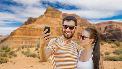 Image showing happy couple taking selfie by smartphone in summer