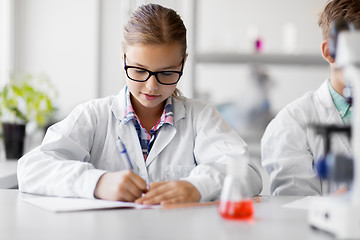 Image showing girl studying chemistry at school laboratory