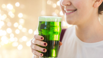 Image showing close up of woman with green beer in glass