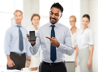 Image showing indian businessman showing smartphone at office