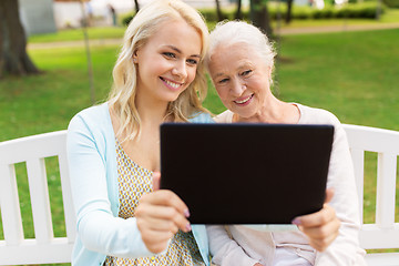 Image showing daughter with tablet pc and senior mother at park