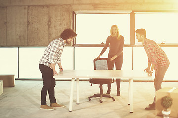Image showing business team carrying white table