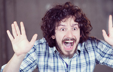 Image showing casual businessman screaming in front of a concrete wall