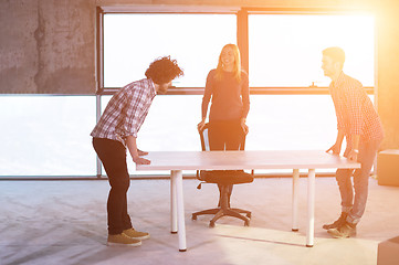 Image showing business team carrying white table