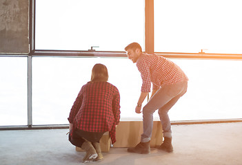 Image showing business team carrying cardboard boxes