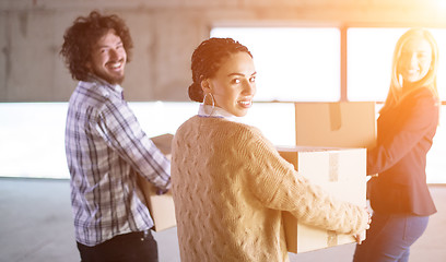 Image showing business team carrying cardboard boxes