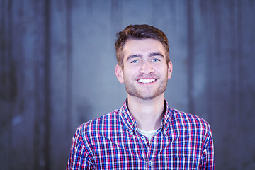 Image showing portrait of casual businessman in front of a concrete wall