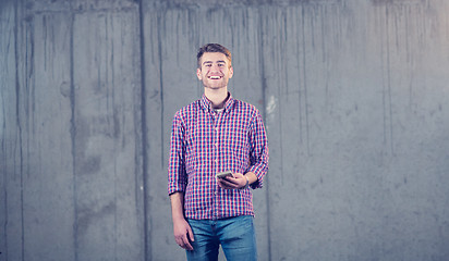 Image showing business man displaying a spread of american dollar cash money