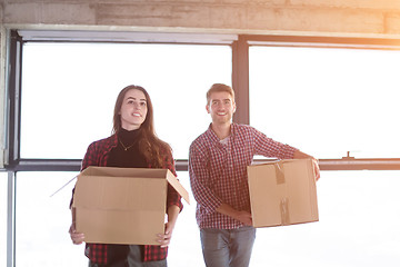 Image showing business team carrying cardboard boxes