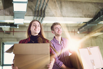 Image showing business team carrying cardboard boxes