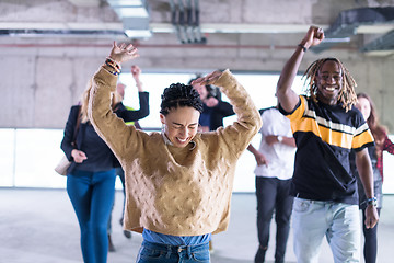 Image showing young multiethnic business people dancing in unfinished startup 