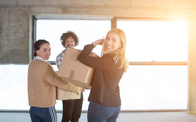 Image showing business team carrying cardboard boxes