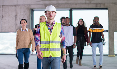 Image showing young multiethnic business people walking through unfinished sta