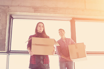 Image showing business team carrying cardboard boxes