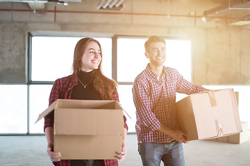 Image showing business team carrying cardboard boxes