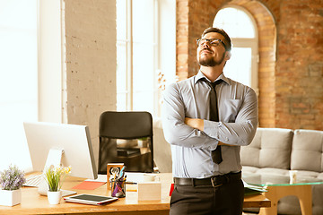 Image showing A young businessman working in office after promotion